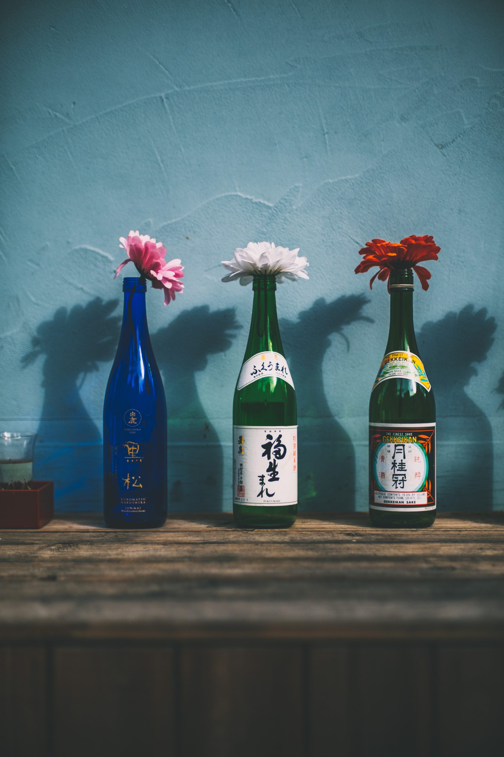 sake bottles being used a vases with flowers