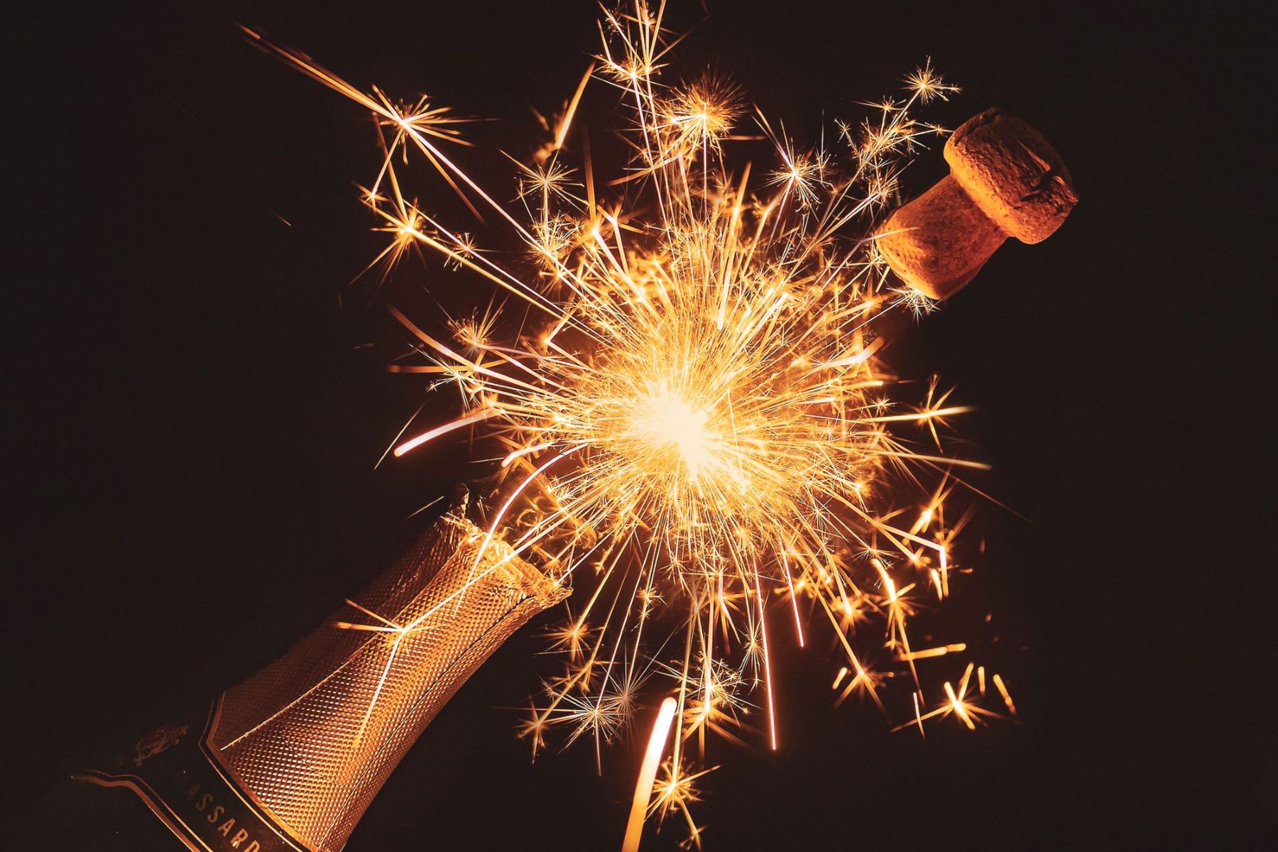 the best sparkling sake in an image like a firework with cork popping